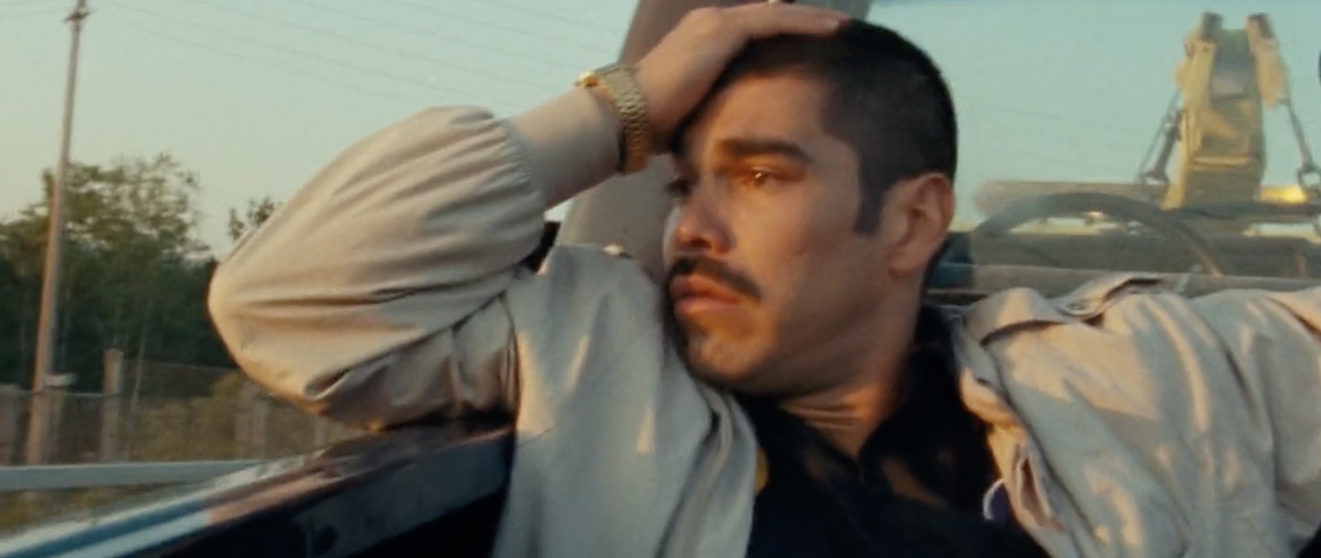 A man pressing a hand to his exhausted face