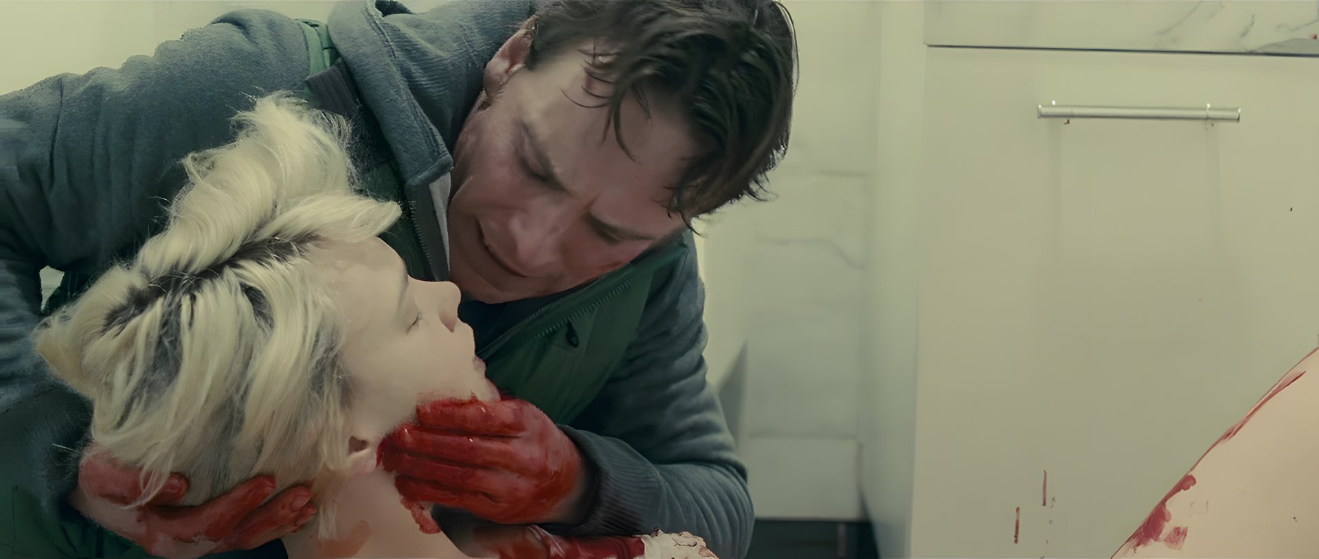 A man cradling a wounded woman