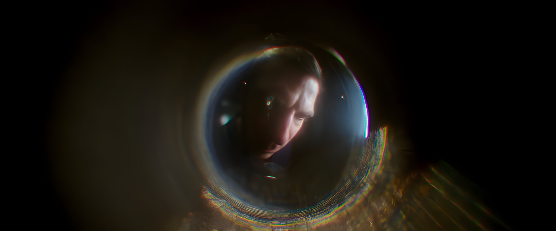 A face distorted through a glass lens