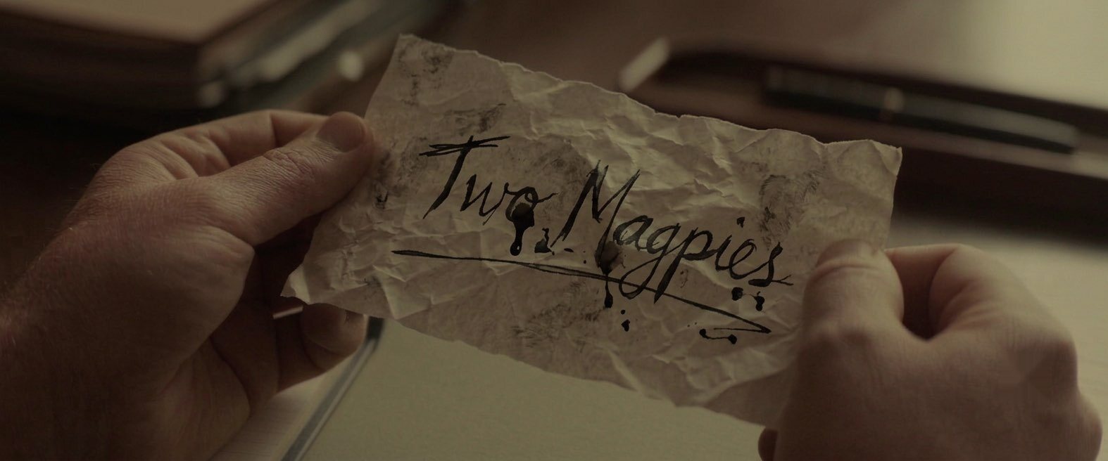 A crumpled note reading Two Magpies