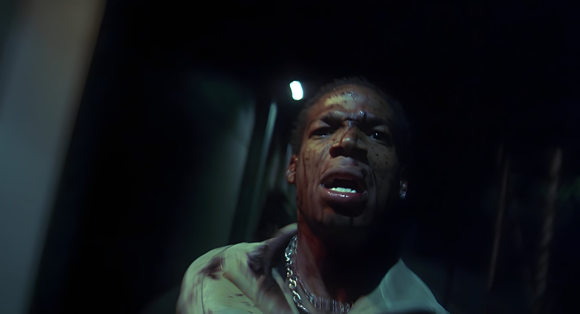 A bloodied man crying out
