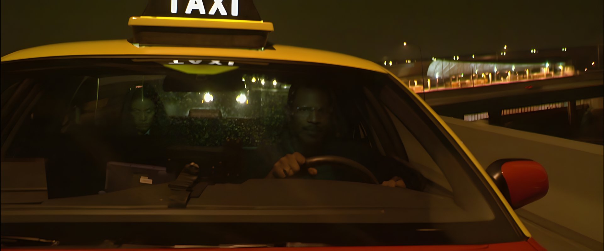 A cab on the road at night
